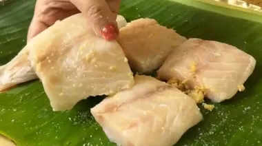 Bhetki Paturi wrapped in banana leaves, coated with mustard paste